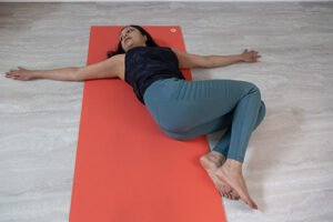 A woman stretching on a mat