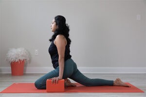 A woman holding yoga blocks