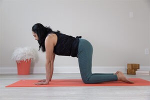 A woman practicing yoga on a mat